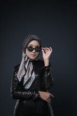 Portrait of a female  wearing a hijab, a form of lifestyle garments for Muslim women, isolated on a background. Eid festive and hijab fashion concept