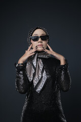 Fototapeta premium Portrait of a female wearing a hijab, a form of lifestyle garments for Muslim women, isolated on a background. Eid festive and hijab fashion concept