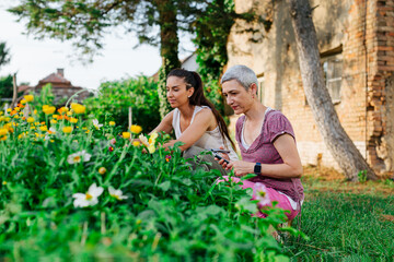 Mother and daughter gardening together.Gardening discovering and teaching.