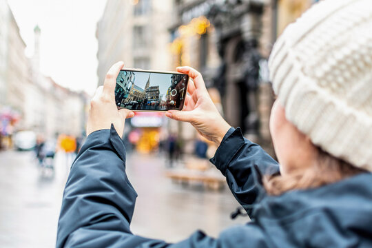 Tourist taking photo of Stephansdom with mobile phone. St. Stephen's Cathedral, Vienna, Austria.
