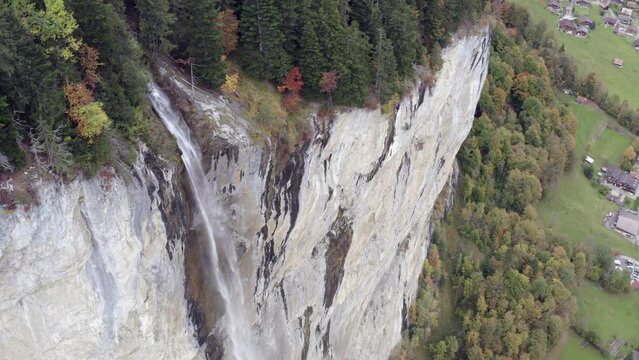 Aerial view of a waterfall surrounded by autumn colors in Lauterbrunnen, Switzerland