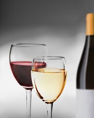 Wines assortment. Red, white wine in glasses and bottles on table background. Wine bar, shop, tasting concept