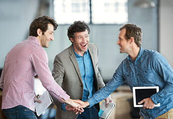 Hands in a huddle as a business man and his colleagues or coworkers cheer and celebrate success, a...