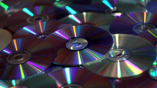 close-up a many compact discs with moving lights