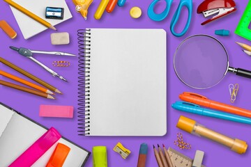 School stationery on background. Colorful math fractions, rulers, open notepad on a purple background. Interesting, fun math for kids. Education, back to school concept