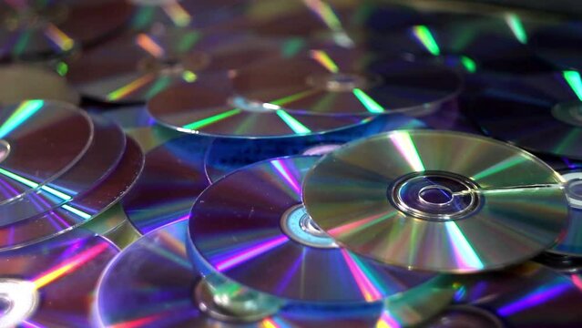 close-up of a many compact discs and other dvds falling dawn