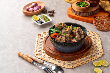 sop buntut or oxtail soup. Made from pieces of beef tail that are seasoned then put in a slightly beef broth with sliced potatoes, carrots, tomatoes, celery. Indonesian traditional culinary