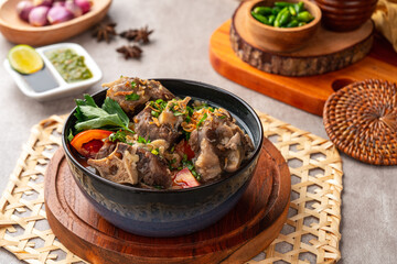 sop buntut or oxtail soup. Made from pieces of beef tail that are seasoned then put in a slightly...