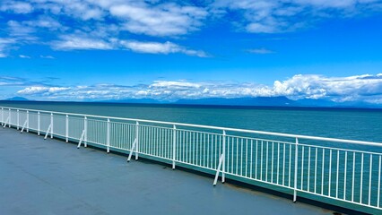 the view from the deck of the covering ship to the sea or ocean is visible Horizon clear blue color of water and sky can be used as a background For title text or advertising calm rest and relaxation
