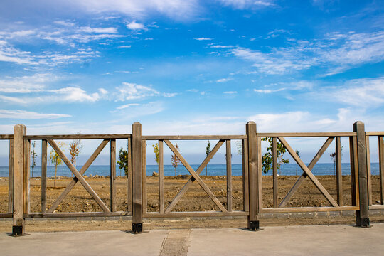 Wooden park and garden railing. Open space blue sky