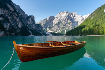 Amazing Sunrise view of Lago di Braies (Pragser Wildsee) with Wooden boats, one of the most beautiful lake in South Tirol, Dolomites mountains, Italy. Popular tourist attraction.