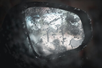 Close up of car mirror during the wash