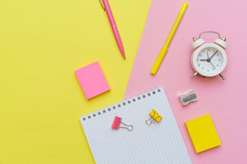 School supplies, stationery on pink background. Pens pencils notepad. Flat lay, top view. Back to school concept