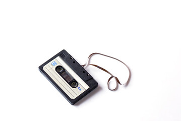 Audio cassette with film on a white background.