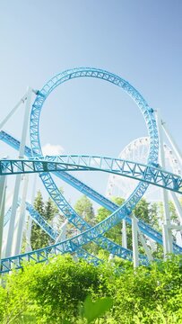 Roller coaster Ride against blue sky. Roller coaster in the amusement park. Cheerful entertainments in park of attractions