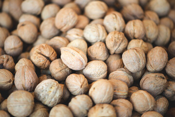 Heap of whole walnuts - full frame natural pattern background detail.