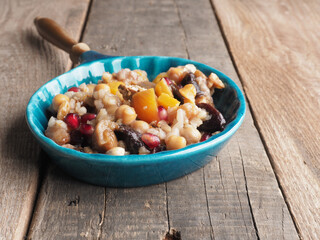 Tasty Noah s ark pudding in a creamic bowl on a rustic wooden table, traditional turkish food