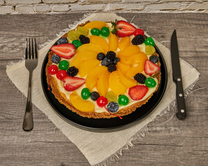 fruitcake with strawberries, blueberries, cherries and peaches, top view
