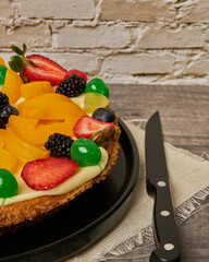 fruitcake with strawberries, blueberries, cherries and peaches diner's eye view