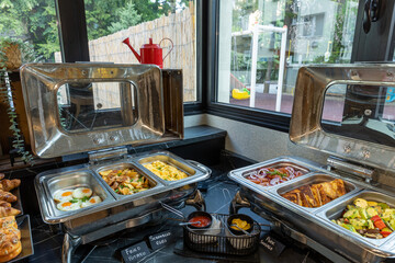 Interior of a hotel restaurant with buffet table