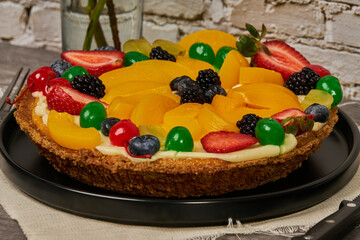 fruit cake with strawberries, blueberries, cherries and peaches side view