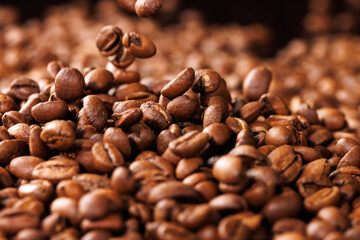 Background with falling coffee beans. Selective focus.