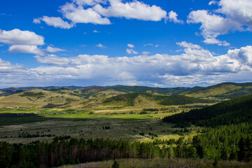 Scenic view of mountains, forests and valleys from mountain peak