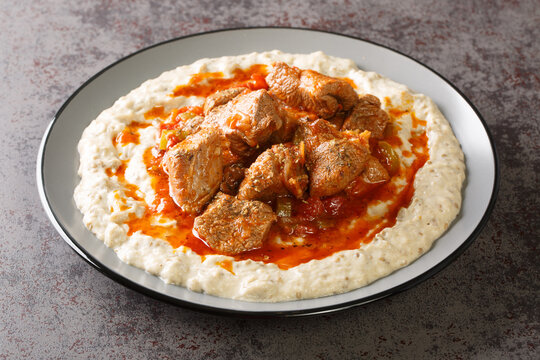 Sultan's Delight or Hunkar Begendi Lamb ragout with pureed eggplant and b&eacute;chamel sauce closeup in the plate on the table. Horizontal