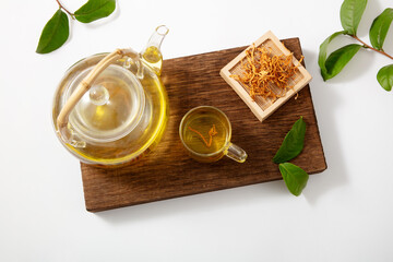 Dried cordyceps militaris mushroom tea in the tray, herbal tea bag of golden cordyceps militaris,...