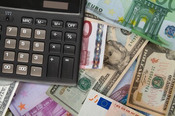 Money cash and a calculator. Savings account whose interest rate and deposit limit are defined by the government