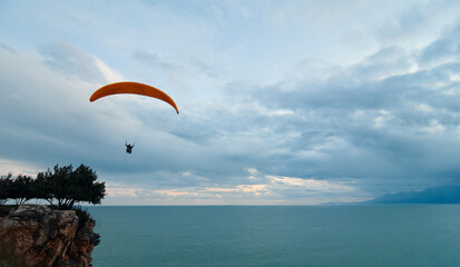 Paragliding on the sea shore, leisure activity.