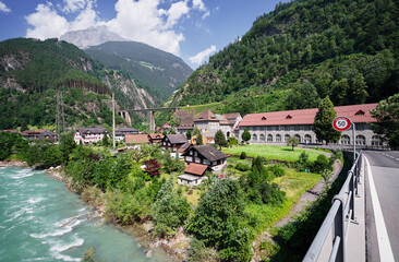 Swiss landscape with river stream and houses.