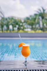 Relaxing weekend. The glass of cocktail on the poolside.