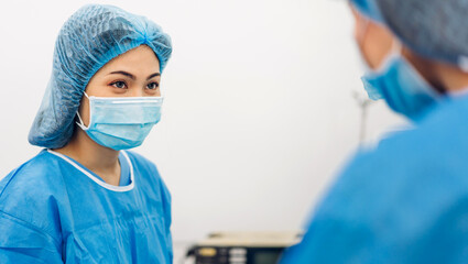 Professional anesthesiologist doctor medical team and assistant preparing patient to gynecological surgery performing operating with surgery equipment in modern hospital operation emergency room