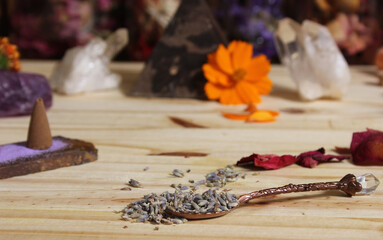 Obraz na płótnie Canvas Dried Lavender and Rose Petals on Table With Incense Cones and Crystals
