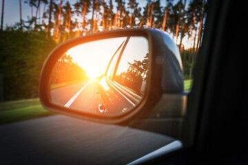 Road trip car mirror. Sun, highway car road reflection in mirror. Summer holidays trip concept.