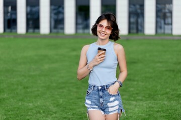 Woman holding coffee in paper cup