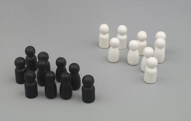 White and black people figures on gray background.