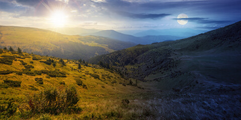 Fototapeta na wymiar view in to the mountain valley at twilight. day and night time change concept. beautiful summer landscape of trascarpathia with forested hills and grassy alpine meadows beneath a sky with sun and moon