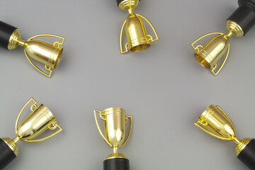 Gold champion cups on gray background with copy space for text.