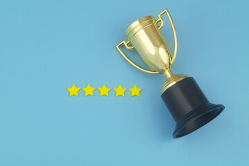 Gold champion cup with 5 stars on blue background. Winner and competition concept.