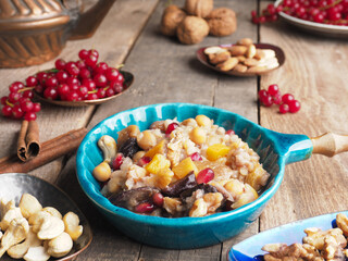 Tasty Noah s ark pudding in a creamic bowl on a rustic wooden table, traditional turkish food