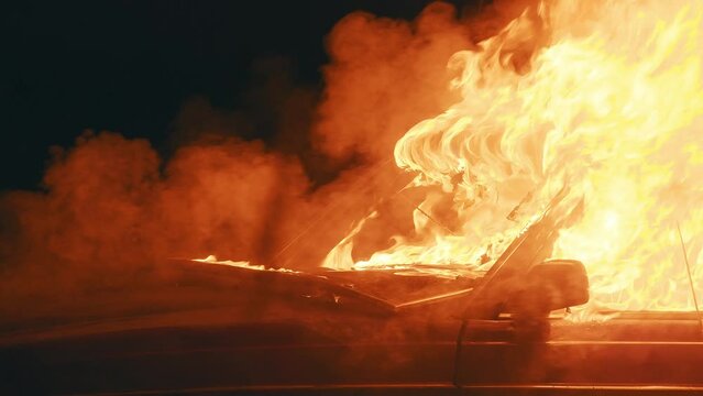 The interior of an old car engulfed in fire