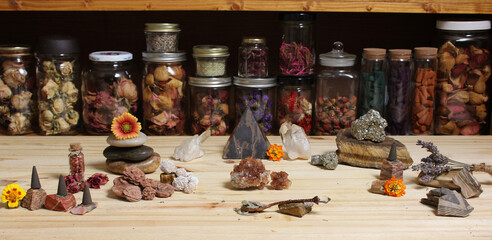 Meditation Altar With Rock Crystals and Flowers. Jars of Herbs in Background