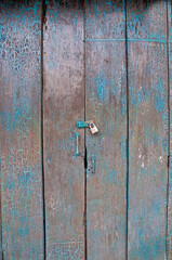 Old dark cyan wooden closed door of a traditional house in Asia
