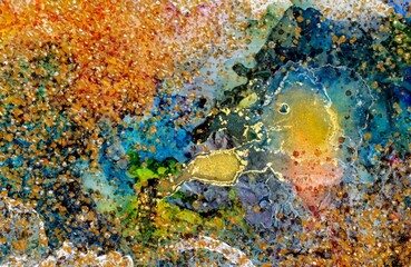 Dark golden dust and gold in the middle of Alcohol ink fluid abstract texture fluid art with gold glitter.