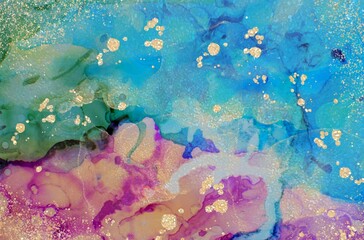 Golden drops on pink and green Alcohol ink fluid abstract texture fluid art with gold glitter and liquid.