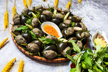 Steamed snails with lemongrass ( Oc doi hap xa).  The ingredients include ground pork, pork leg, tamarind, vermicelli, spices, puree and then leave the shell.