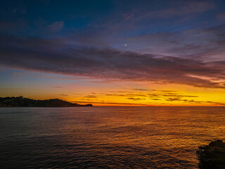 Sunrise over the sea with high cloud