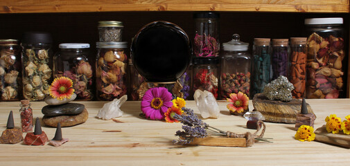 Meditation Altar With Rock Crystals and Flowers. Jars of Herbs in Background